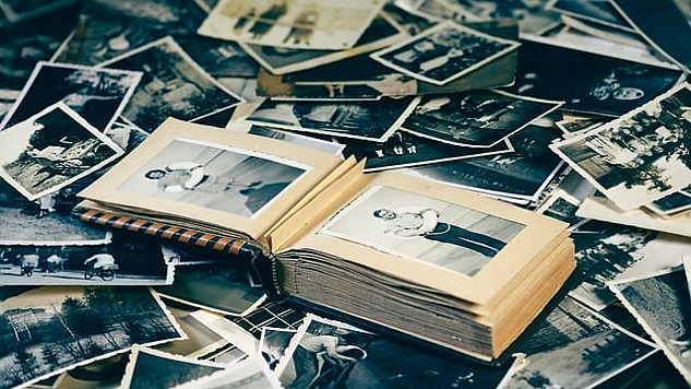 a bunch of old photos and a book containing old photoes