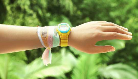A bracelet made from fabric woven with special energy-harvesting strands that collect electricity from the sun and motion. (Credit: Georgia Tech)