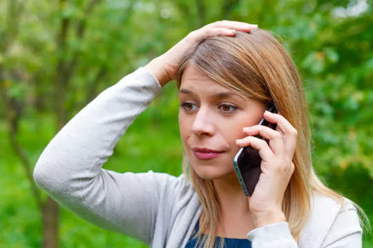 Worried woman using a smartphone