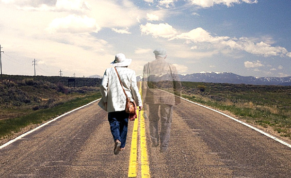 ann older couple walking down the middle of the road holding hands
