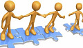 stick figures standing on joined puzzle pieces holding hands and reaching out to another figure on a separate puzzle piece