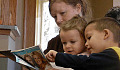 Mother reads with children. Diana Ramsey, CC BY