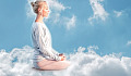 woman sitting on a cloud meditating