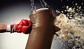 someone wearing boxing gloves hitting a punching bag