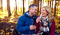 a couple in their fifties sharing laughter and a glass of wine