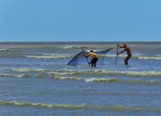 Fishermen set a net in Jericoacoara, Brazil.