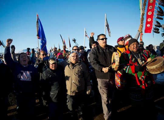 Protesters march at Oceti Sakowin camp, where people gathered to protest the Dakota Access oil pipeline (why covering the environment is one of the most dangerous beats in journalism)