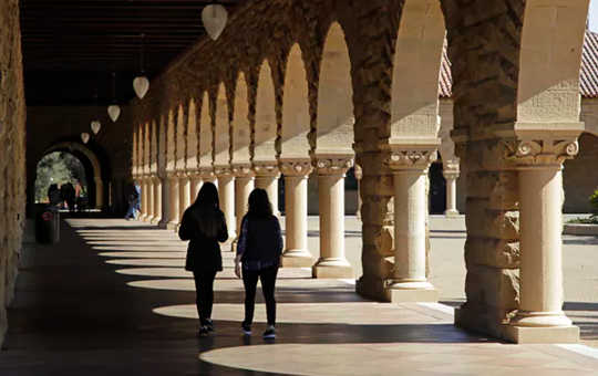 Students walk on the Stanford University campus in Santa Clara, Calif. Stanford has a $24 billion endowment.  (the real scandal of american universities is subsidized privilege)