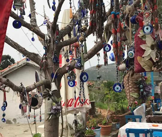 A tree adorned with the evil eye symbol in a Turkish village.  (scarabs phalluses evil eyes how ancient amulets tried to ward off disease)