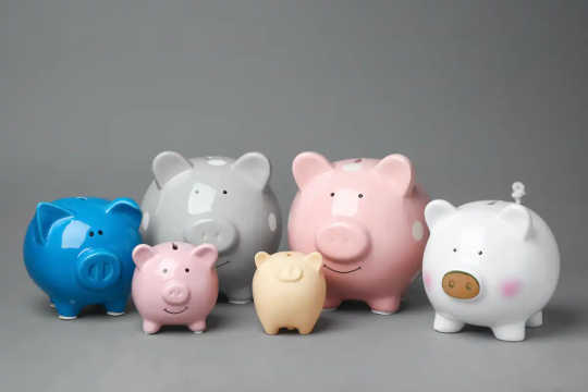 Piggy banks of varying colours and sizes.