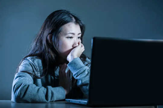 Woman staring at computer screen