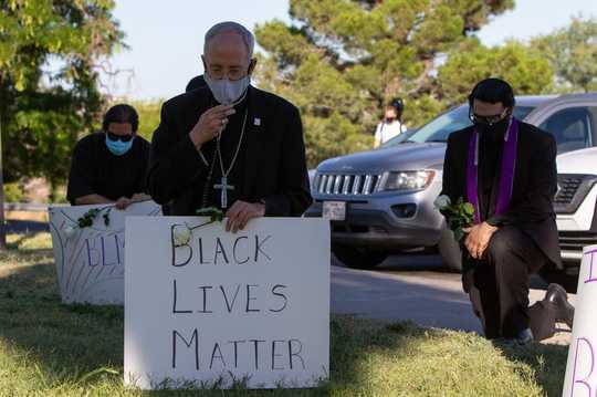 Why Catholic Priests Are Kneeling With Protesters