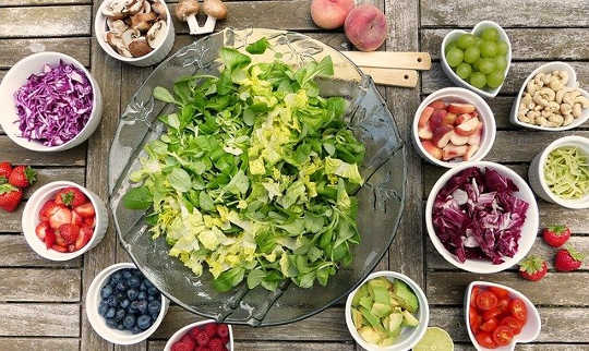 salad with small bowls of raw ingredients