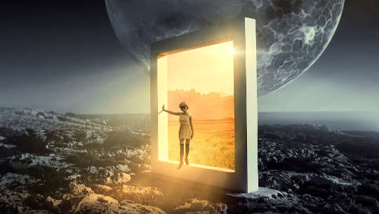 a child in an open door in a bleak landscape, yet the open door leads to bright light