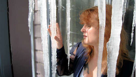 woman looking out a door through a "curtain" or icicles