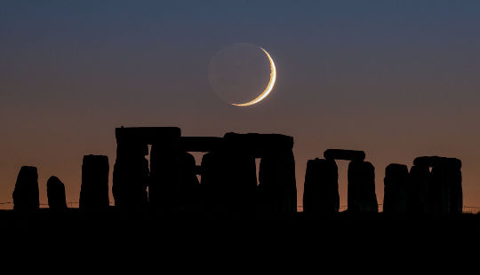Crescent moon setting over Stonehenge