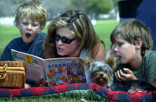 woman reading to two young children