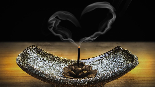 incense smoke floating up in the shape of a heart