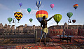 a woman standing in front of a lot of released hot air balloons