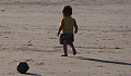 a very young child alone on a beach