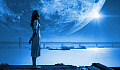 a woman standing with a huge moon in the background