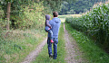 father holding son in his arms and walking down the road