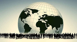 many people surrounding a black and white globe of planet earth