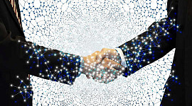 two business men shaking hands showing the energy connecting in both hands and arms