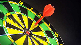 a dart right in the bull's eye of a dartboard